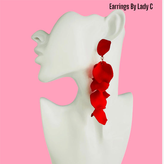 A mannequin head showcasing long red alloy petal-shaped earrings.