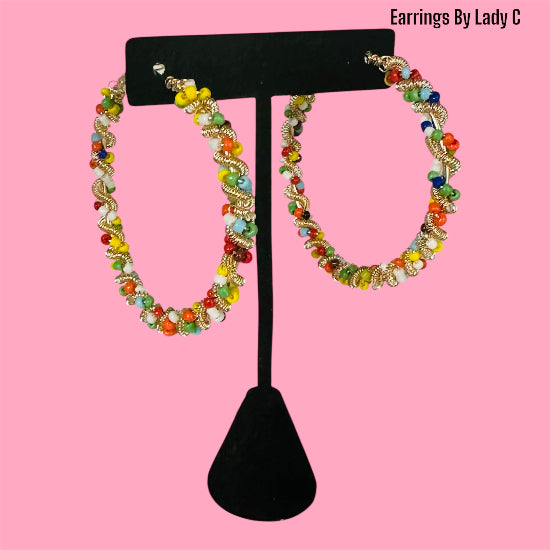 Rainbow Twist colorful hoop earrings with a vibrant swirl design