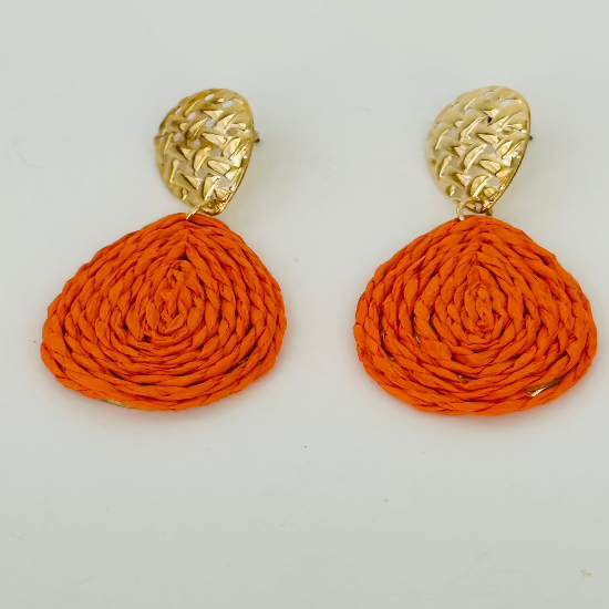 Close-up image of handmade raffia earrings with natural woven textures and vibrant colors, ideal for boho-chic outfits.