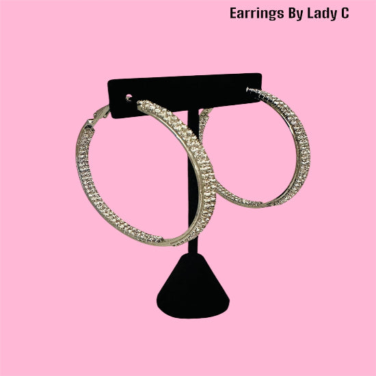 Elegant silver hoop earrings adorned with sparkling rhinestones – perfect for a chic and stylish look.