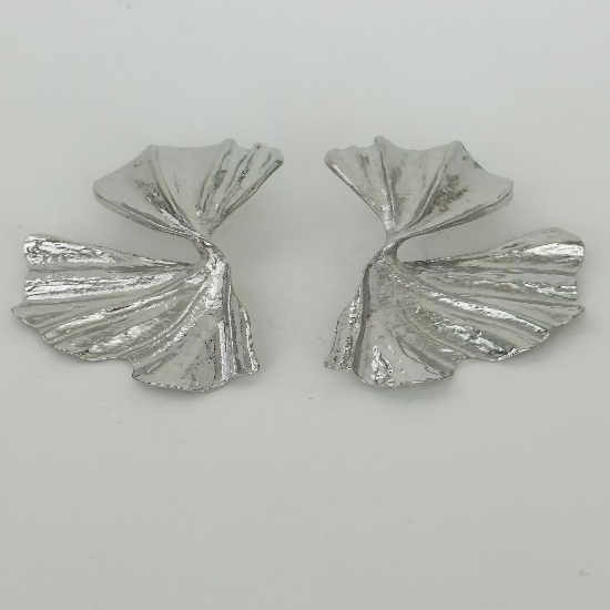 Close-up image of minimalist stud earrings with a sparkling gemstone, ideal for timeless and elegant everyday wear.