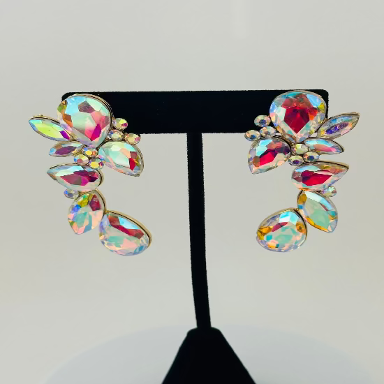 Multicolored gemstone earrings on a black display stand against a light gray background