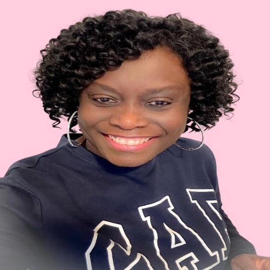 Person wearing a navy blue sweatshirt with white text on a pink background