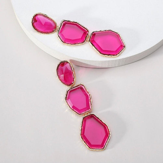 A pair of elegant dangle earrings with intricate detailing, perfect for adding a stylish touch to any outfit.