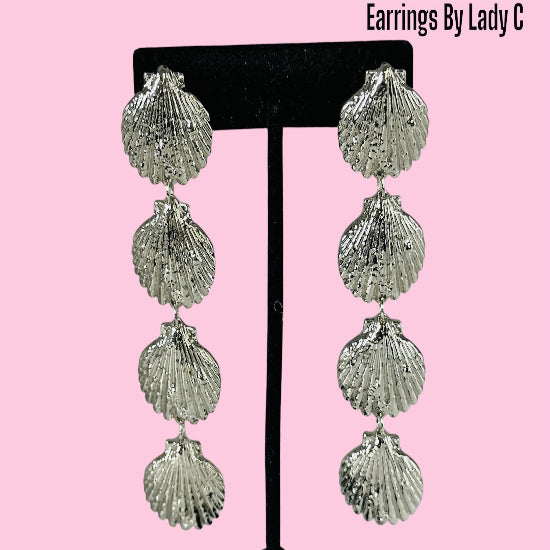 Ocean Life gold shell earrings inspired by the sea, with a polished coastal design