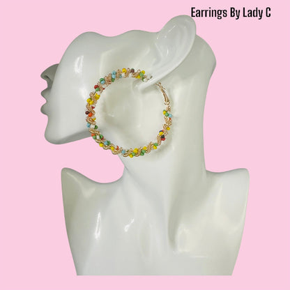 Rainbow Twist colorful hoop earrings with a vibrant swirl design


