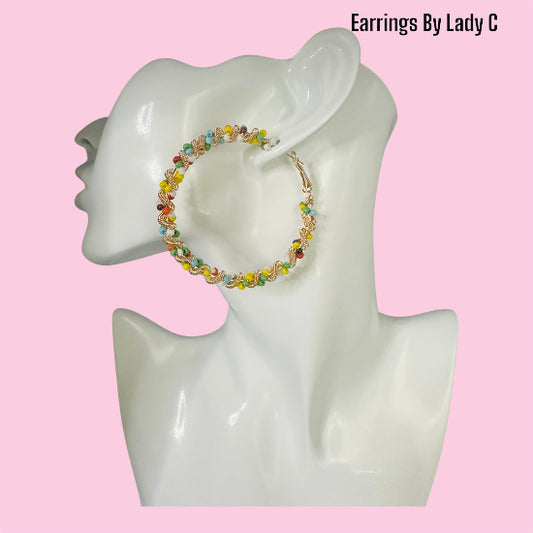 Rainbow Twist colorful hoop earrings with a vibrant swirl design

