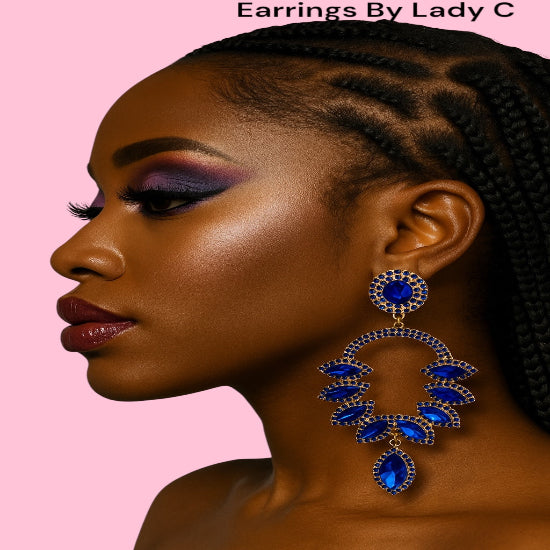 Woman wearing blue earrings with a pink background