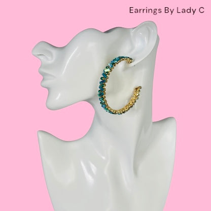 Gold and blue hoop earrings. 