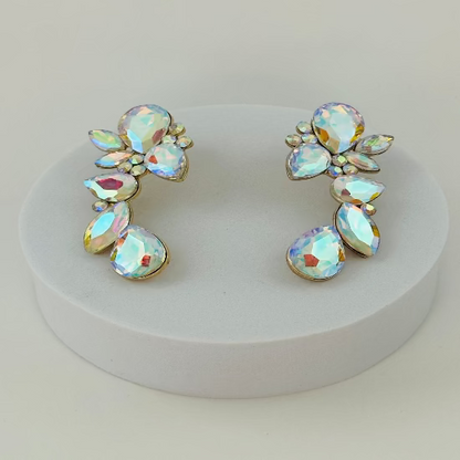 Pair of earrings with iridescent gemstones on a white stand