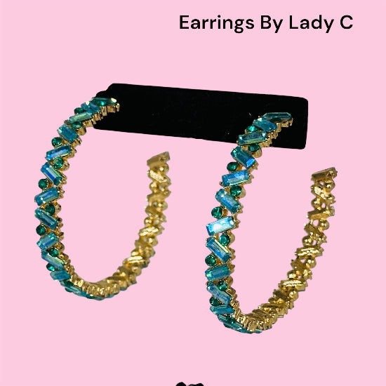 Gold and blue hoop earrings .