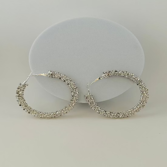 Close-up of sparkling rhinestone hoop earrings with a sleek and elegant design, perfect for any occasion. 