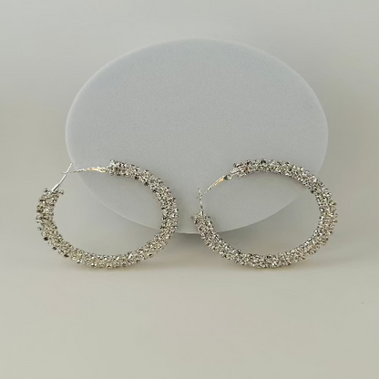 Close-up of sparkling rhinestone hoop earrings with a sleek and elegant design, perfect for any occasion. 