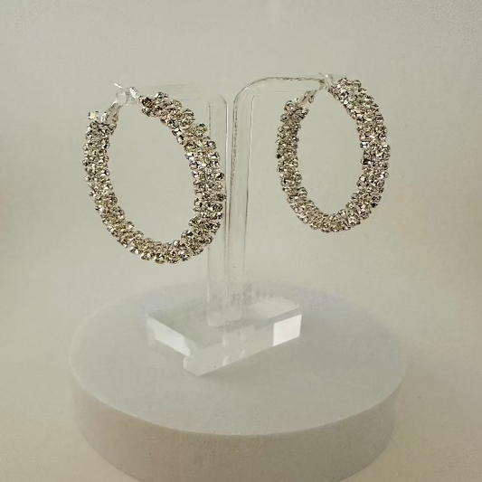 Close-up of sparkling rhinestone hoop earrings with a sleek and elegant design, perfect for any occasion. 