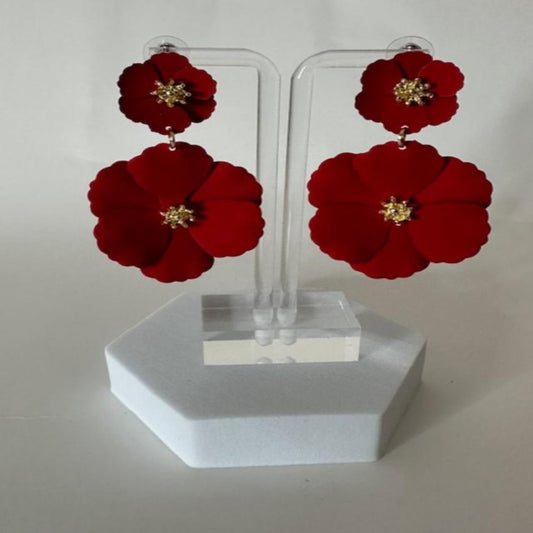 Close-up image of red floral earrings with intricate petal details, perfect for making a bold and elegant statement.

